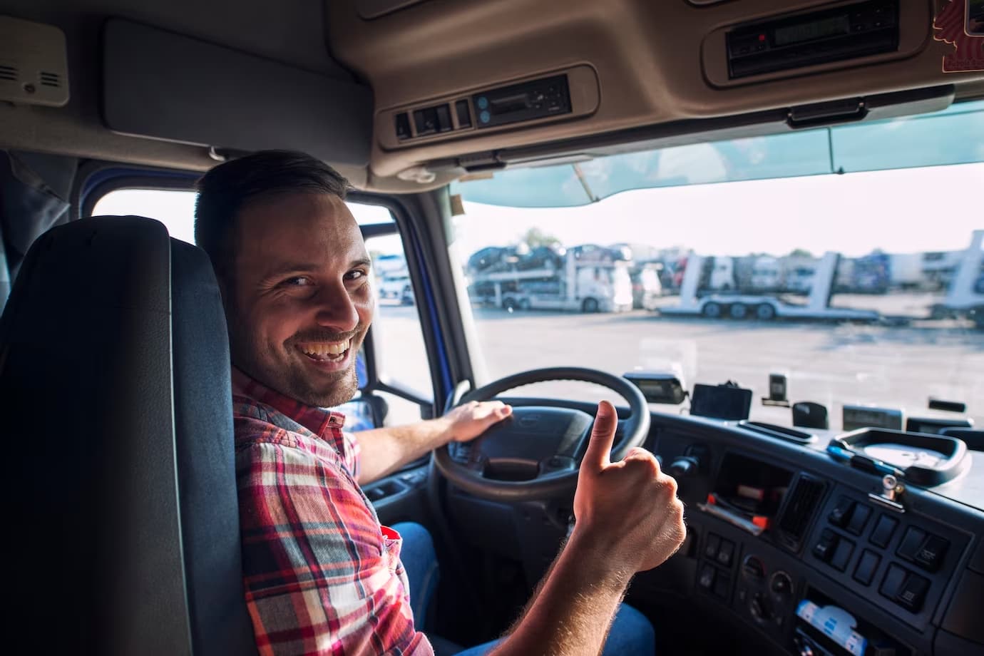Truck driver smiling behind the wheel