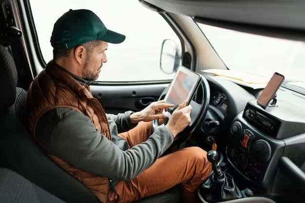 Driver checking paperwork on a tablet inside the cab